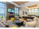 A modern community living room features stylish furniture, fireplace, and plenty of seating at 139 N Prairie Falcon Pkwy, Brighton, CO 80601