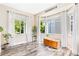Bright living room boasts beautiful hardwood floors and large windows with backyard views at 139 N Prairie Falcon Pkwy, Brighton, CO 80601