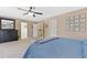 Bright main bedroom features a ceiling fan, carpet and access to two closets at 139 N Prairie Falcon Pkwy, Brighton, CO 80601
