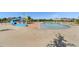A community pool features a waterslide, lounge chairs, and a play area for  at 139 N Prairie Falcon Pkwy, Brighton, CO 80601