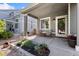 Cozy covered porch with seating area and decorative flower planters, a warm welcome to the home at 139 N Prairie Falcon Pkwy, Brighton, CO 80601