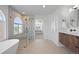 Bright bathroom features a soaking tub, glass shower, and modern vanity with wood cabinets at 22935 E River Chase Way, Parker, CO 80138