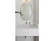 Modern bathroom features a stylish mirror, sleek sink, and elegant white countertops at 22935 E River Chase Way, Parker, CO 80138