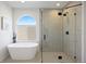 Bright bathroom featuring a freestanding tub, glass enclosed shower, and modern fixtures at 22935 E River Chase Way, Parker, CO 80138