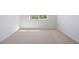 Empty bedroom features neutral carpet, white walls, and a view out the window at 22935 E River Chase Way, Parker, CO 80138