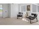 Sunlit room with two black chairs and a side table near a window and door at 22935 E River Chase Way, Parker, CO 80138