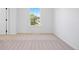 Bright bedroom featuring neutral carpet, white walls, and a window looking out to the street at 22935 E River Chase Way, Parker, CO 80138
