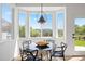 Bright dining area features modern black chairs and a marble table with views at 22935 E River Chase Way, Parker, CO 80138