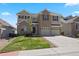 Attractive two-story home with a well-maintained lawn, three-car garage, and a welcoming brick facade at 22935 E River Chase Way, Parker, CO 80138