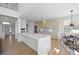 Contemporary kitchen with a spacious island, stainless steel appliances, and an open dining area at 22935 E River Chase Way, Parker, CO 80138