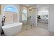 Luxurious bathroom featuring a freestanding tub, glass enclosed shower, and modern fixtures at 22935 E River Chase Way, Parker, CO 80138