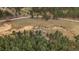 An aerial view showcasing a tree-filled lot and the surrounding wooded areas at 7510 Blue Creek Rd, Evergreen, CO 80439