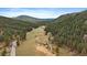 Picturesque aerial view of a valley surrounded by mountains and lush green forests at 7510 Blue Creek Rd, Evergreen, CO 80439