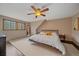 Well-lit bedroom featuring a large bed, area rug, and windows for natural light at 7510 Blue Creek Rd, Evergreen, CO 80439