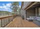 Spacious outdoor deck with comfortable seating and a view of the surrounding landscape at 7510 Blue Creek Rd, Evergreen, CO 80439