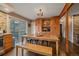 Dining area with wooden table, chairs, bench seating and a view of the outside deck at 7510 Blue Creek Rd, Evergreen, CO 80439