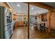 Open concept kitchen with stainless steel appliances, wooden cabinets, granite counters, and a dining table at 7510 Blue Creek Rd, Evergreen, CO 80439