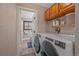 Well-equipped laundry room with modern washer and dryer and access to a compact bathroom at 7510 Blue Creek Rd, Evergreen, CO 80439