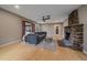 Inviting living room featuring a stone fireplace, a cozy couch, and wood flooring at 7510 Blue Creek Rd, Evergreen, CO 80439