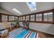 Bright sunroom with many windows offering beautiful views of the surrounding nature at 7510 Blue Creek Rd, Evergreen, CO 80439