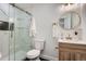 Modern bathroom featuring marble tiling, glass shower, and updated fixtures at 7452 W Cedar Cir, Lakewood, CO 80226