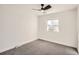 Comfortable bedroom with carpeted floor, ceiling fan, and a sun-filled window at 7452 W Cedar Cir, Lakewood, CO 80226