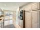 Modern kitchen featuring stainless steel appliances, light colored cabinets, and ample storage at 7452 W Cedar Cir, Lakewood, CO 80226