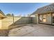 Enclosed patio area with brick accents, concrete flooring, a privacy fence and access to the yard at 7452 W Cedar Cir, Lakewood, CO 80226