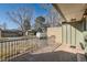 Covered front porch featuring brick accents, wrought iron railing, and landscaped surroundings at 7452 W Cedar Cir, Lakewood, CO 80226