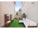 This backyard features a white couch, a stone fire pit and artificial grass at 6764 Osage St, Denver, CO 80221