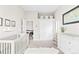 View of a bright Bedroom room featuring a crib, dresser, and fur rug at 6764 Osage St, Denver, CO 80221