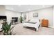 A bright bedroom features neutral walls, a desk, an exercise bike and plush carpet at 6764 Osage St, Denver, CO 80221
