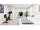 A bedroom with a stationary bike, desk, neutral walls and plush carpeting at 6764 Osage St, Denver, CO 80221