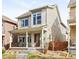 Charming two-story home with a welcoming front porch and beautifully landscaped front yard at 6764 Osage St, Denver, CO 80221