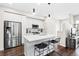 Bright kitchen features a stainless steel refrigerator, and an island with seating at 6764 Osage St, Denver, CO 80221
