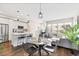 Stylish living room featuring a modern kitchen, dining area, and comfortable seating with natural light at 6764 Osage St, Denver, CO 80221