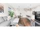 Inviting living room featuring a modern couch, dining area, and stylish decor at 6764 Osage St, Denver, CO 80221