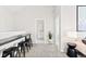 Wide shot of a living room with a snack bar and adjacent bathroom at 6764 Osage St, Denver, CO 80221