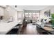 Open floor plan with kitchen island leading to living space with ample windows and comfortable seating at 6764 Osage St, Denver, CO 80221