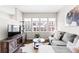 Bright living room features a modern television, an area rug, and comfortable seating at 6764 Osage St, Denver, CO 80221