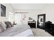 Comfortable main bedroom featuring neutral colors and a sliding barn door to the ensuite bathroom at 6764 Osage St, Denver, CO 80221