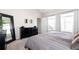 Cozy main bedroom with plush carpets and stylish decor and ensuite bathroom access at 6764 Osage St, Denver, CO 80221