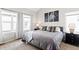 Bright main bedroom with plush carpets and stylish decor and neutral tones at 6764 Osage St, Denver, CO 80221