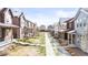 Charming street view featuring colorful homes, landscaping, and sidewalks leading to each residence at 6764 Osage St, Denver, CO 80221