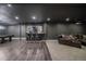 Finished basement with a bar, pool table, leather couch and hardwood flooring at 14589 Hagus Pl, Parker, CO 80134