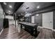 Finished basement featuring a pool table, kitchenette, stylish lighting, and neutral color scheme at 14589 Hagus Pl, Parker, CO 80134