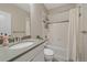 Bright bathroom featuring a shower-tub, tile accents, vanity with gray countertop and a large mirror at 14589 Hagus Pl, Parker, CO 80134