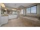 Bright bathroom with a soaking tub, walk-in shower, dual sinks, and plenty of cabinet space at 14589 Hagus Pl, Parker, CO 80134