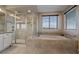 Relaxing bathroom with a walk-in shower, soaking tub, and tiled walls by a window with blinds at 14589 Hagus Pl, Parker, CO 80134