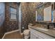 Elegant half bathroom showcasing patterned wallpaper, a modern sink, and stylish fixtures at 14589 Hagus Pl, Parker, CO 80134